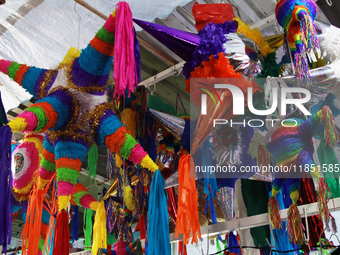 Different pinatas are seen at a tianguis, where various items are sold for the Christmas season and the posadas, in the Tlalpan Center in Me...