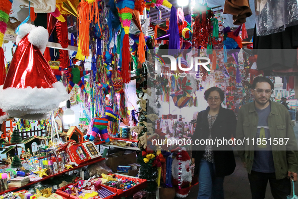 People attend a market where different items are sold for the Christmas and Posadas season in the Tlalpan Center in Mexico City, Mexico, on...