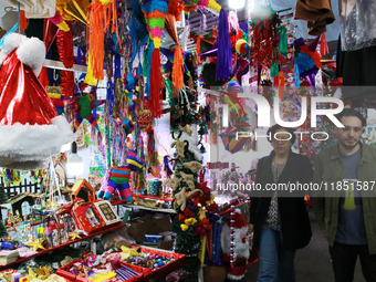 People attend a market where different items are sold for the Christmas and Posadas season in the Tlalpan Center in Mexico City, Mexico, on...