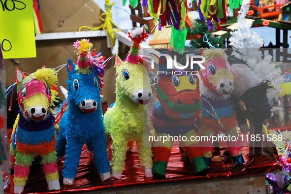 Different pinatas are seen at a tianguis, where various items are sold for the Christmas season and the posadas, in the Tlalpan Center in Me...