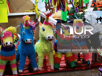 Different pinatas are seen at a tianguis, where various items are sold for the Christmas season and the posadas, in the Tlalpan Center in Me...