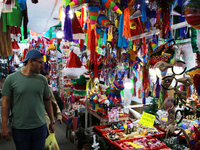 A man walks through a market where various items are sold for the Christmas season and the posadas, installed in the Tlalpan Center in Mexic...