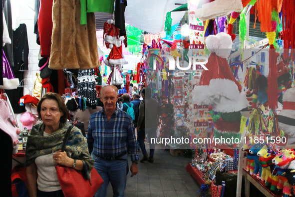 People attend a market where different items are sold for the Christmas and Posadas season in the Tlalpan Center in Mexico City, Mexico, on...