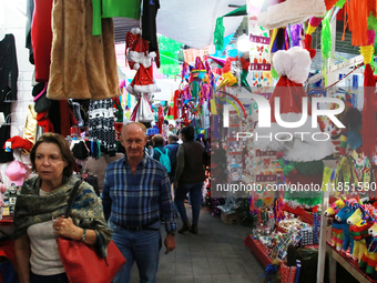 People attend a market where different items are sold for the Christmas and Posadas season in the Tlalpan Center in Mexico City, Mexico, on...