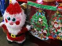 Various Santa Claus items are seen at a market where different products are sold for the Christmas and Posadas season, installed in the Tlal...