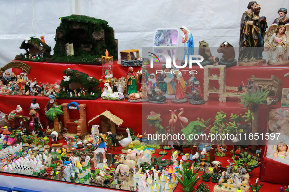 Figures for a nativity scene are available in a market where various products are sold for the Christmas season and the posadas, located in...