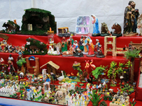 Figures for a nativity scene are available in a market where various products are sold for the Christmas season and the posadas, located in...