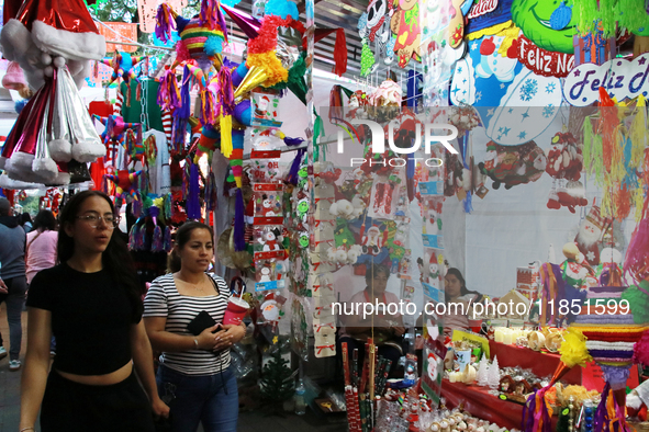 People attend a market where different items are sold for the Christmas and Posadas season in the Tlalpan Center in Mexico City, Mexico, on...