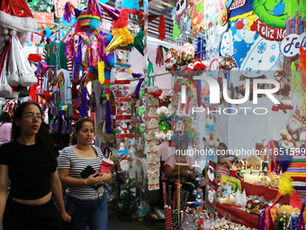 People attend a market where different items are sold for the Christmas and Posadas season in the Tlalpan Center in Mexico City, Mexico, on...