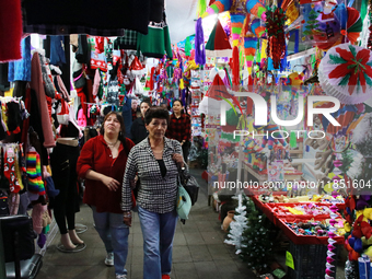 People attend a market where different items are sold for the Christmas and Posadas season in the Tlalpan Center in Mexico City, Mexico, on...