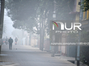 People travel to work and students go to school on a cold and foggy day in Siliguri, India, on December 10, 2024. (