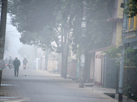 People travel to work and students go to school on a cold and foggy day in Siliguri, India, on December 10, 2024. (