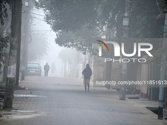 People travel to work and students go to school on a cold and foggy day in Siliguri, India, on December 10, 2024. (