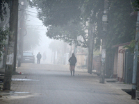 People travel to work and students go to school on a cold and foggy day in Siliguri, India, on December 10, 2024. (