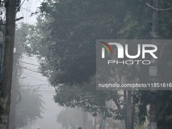 People travel to work and students go to school on a cold and foggy day in Siliguri, India, on December 10, 2024. (