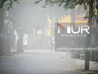 People travel to work and students go to school on a cold and foggy day in Siliguri, India, on December 10, 2024. (