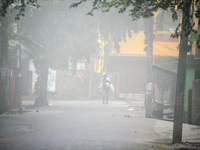 People travel to work and students go to school on a cold and foggy day in Siliguri, India, on December 10, 2024. (