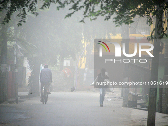 People travel to work and students go to school on a cold and foggy day in Siliguri, India, on December 10, 2024. (