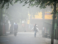 People travel to work and students go to school on a cold and foggy day in Siliguri, India, on December 10, 2024. (