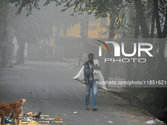 A rag picker searches for plastic bottles and other recyclable items in Siliguri, India, on December 10, 2024. (