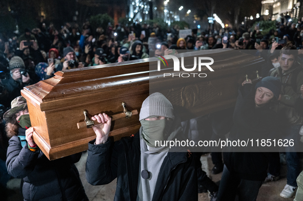 This photograph shows an image of Georgian billionaire Bidzina Ivanishvili inside a coffin after anti-government demonstrators set it on fir...