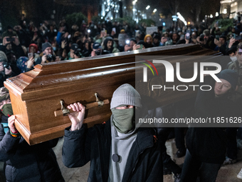 This photograph shows an image of Georgian billionaire Bidzina Ivanishvili inside a coffin after anti-government demonstrators set it on fir...