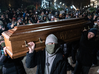 This photograph shows an image of Georgian billionaire Bidzina Ivanishvili inside a coffin after anti-government demonstrators set it on fir...