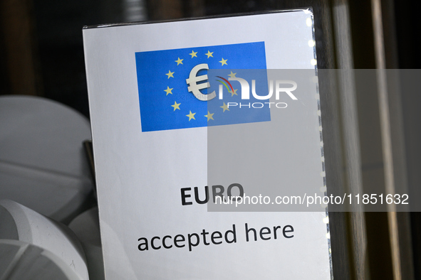 A sign reading 'Euro accepted here' is seen in Warsaw, Poland on 09 December, 2024. 