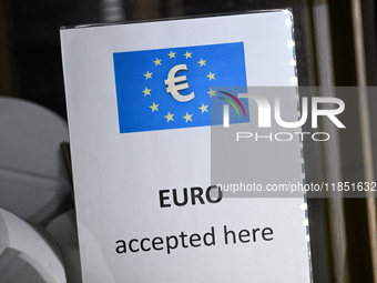 A sign reading 'Euro accepted here' is seen in Warsaw, Poland on 09 December, 2024. (