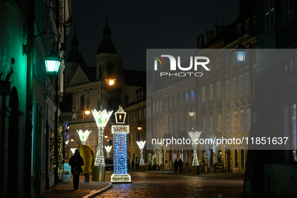 Illuminated Christmas decorations and caroussels are seen in Warsaw, Poland on 09 December, 2024. 