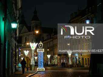 Illuminated Christmas decorations and caroussels are seen in Warsaw, Poland on 09 December, 2024. (