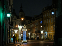 Illuminated Christmas decorations and caroussels are seen in Warsaw, Poland on 09 December, 2024. (