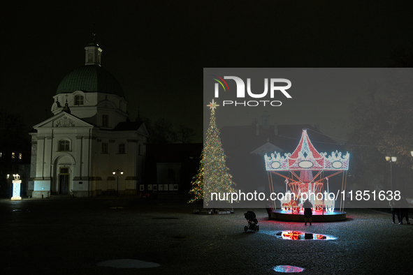 Illuminated Christmas decorations and caroussels are seen in Warsaw, Poland on 09 December, 2024. 