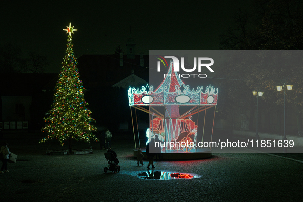 Illuminated Christmas decorations and caroussels are seen in Warsaw, Poland on 09 December, 2024. 