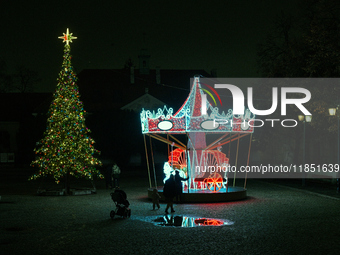 Illuminated Christmas decorations and caroussels are seen in Warsaw, Poland on 09 December, 2024. (