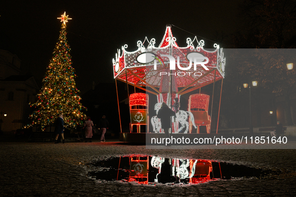 Illuminated Christmas decorations and caroussels are seen in Warsaw, Poland on 09 December, 2024. 