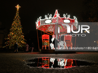 Illuminated Christmas decorations and caroussels are seen in Warsaw, Poland on 09 December, 2024. (