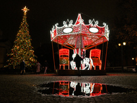 Illuminated Christmas decorations and caroussels are seen in Warsaw, Poland on 09 December, 2024. (