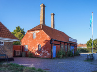 An old red building in the port is seen in Ronne, Bornholm Island, Denmark, on August 6, 2024. (