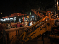 People are seen near an accident site where a BEST bus loses control and crushes a few vehicles, injuring 49 people and killing 7 people in...