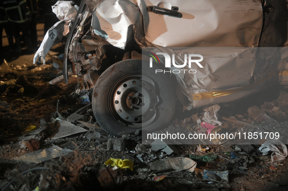 A damaged car body and tire are seen at an accident site where a BEST bus loses control and crushes a few vehicles, injuring 49 people and k...