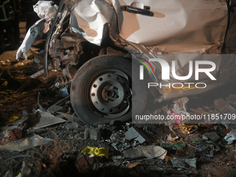 A damaged car body and tire are seen at an accident site where a BEST bus loses control and crushes a few vehicles, injuring 49 people and k...