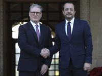 Britain's Prime Minister Keir Starmer is welcomed by Cyprus' President Nikos Christodoulides at the Presidential Palace in Nicosia, Cyprus,...