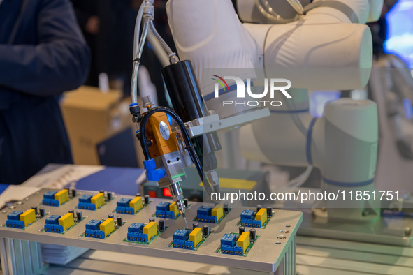 An automatic spraying robot is seen at the 2024 Global Artificial Intelligence Product Application Expo in Suzhou, China, on December 10, 20...