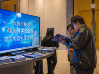 A visitor consults about AIGC products at the 2024 Global Artificial Intelligence Product Application Expo in Suzhou, China, on December 10,...