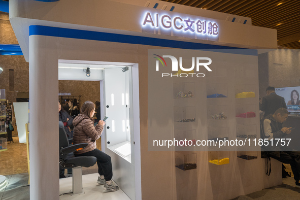 A visitor experiences an AIGC cultural cabin at the 2024 Global Artificial Intelligence Product Application Expo in Suzhou, China, on Decemb...