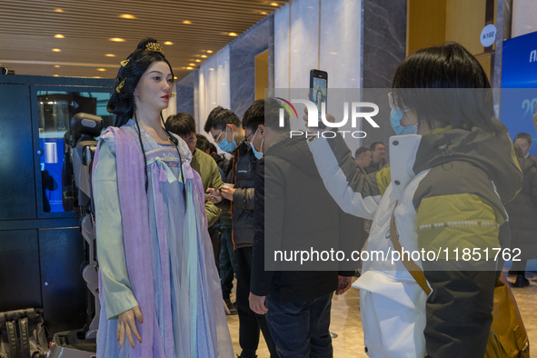 Visitors look at robot products at the 2024 Global Artificial Intelligence Product Application Expo in Suzhou, China, on December 10, 2024. 