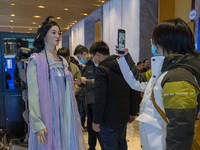 Visitors look at robot products at the 2024 Global Artificial Intelligence Product Application Expo in Suzhou, China, on December 10, 2024....