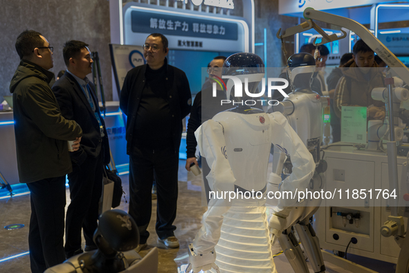 Visitors look at robot products at the 2024 Global Artificial Intelligence Product Application Expo in Suzhou, China, on December 10, 2024. 