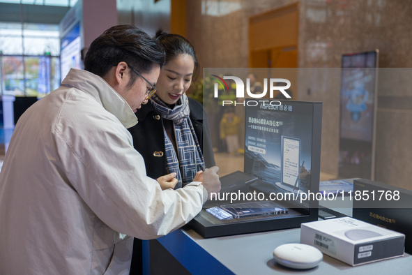 A visitor tries out a handwritten translation system at the 2024 Global Artificial Intelligence Product Application Expo in Suzhou, China, o...